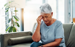 Elderly woman at home suffering from confusion or frustration.